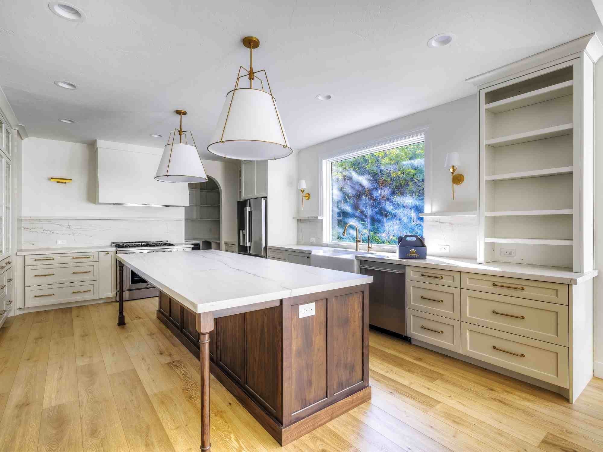 Bright kitchen remodel by Marshall Homes in Olympus Cove, Utah featuring large island, custom cabinets, and open layout