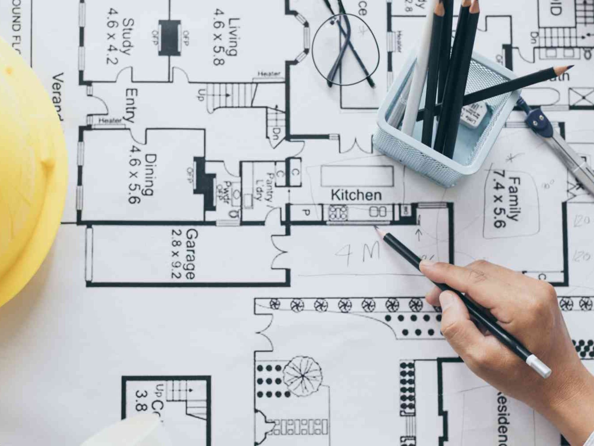 Overhead view of a person working on architectural drawings for a Marshall Homes project in Salt Lake City, UT
