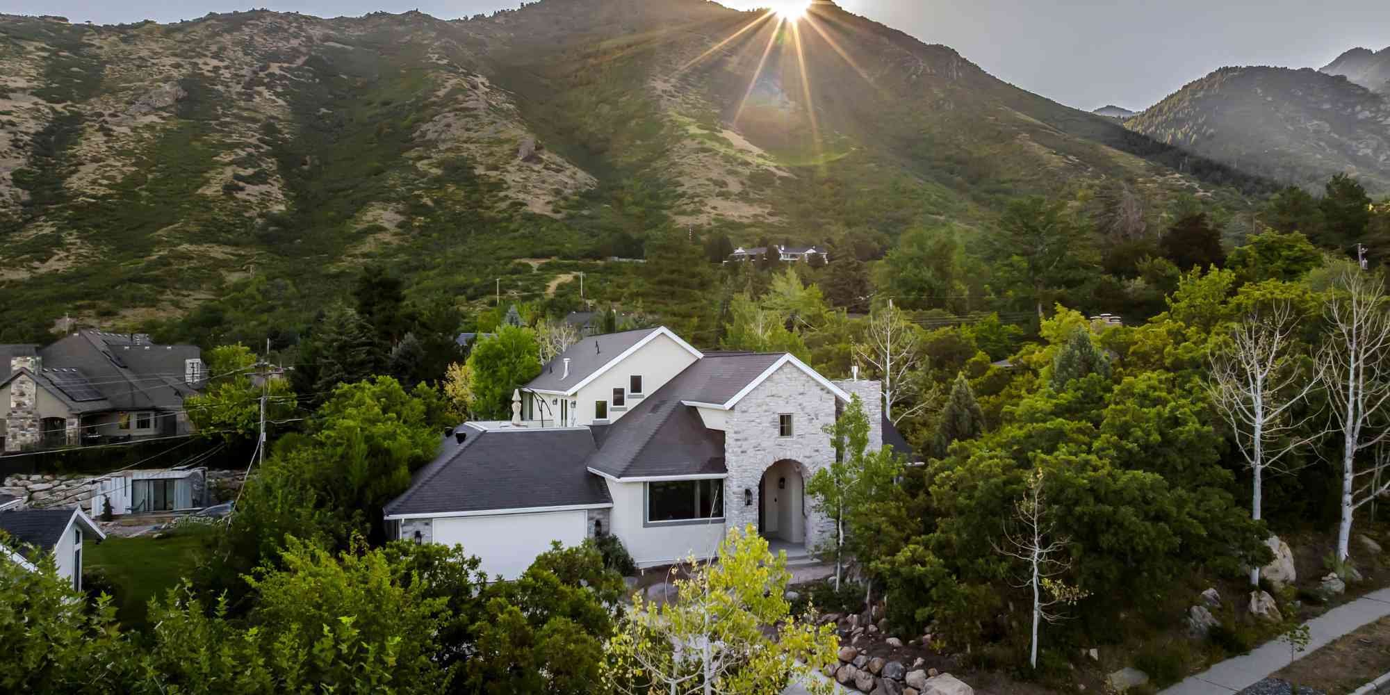 Modern Marshall Homes home remodel in Salt Lake City, UT featuring scenic mountain views at sunset