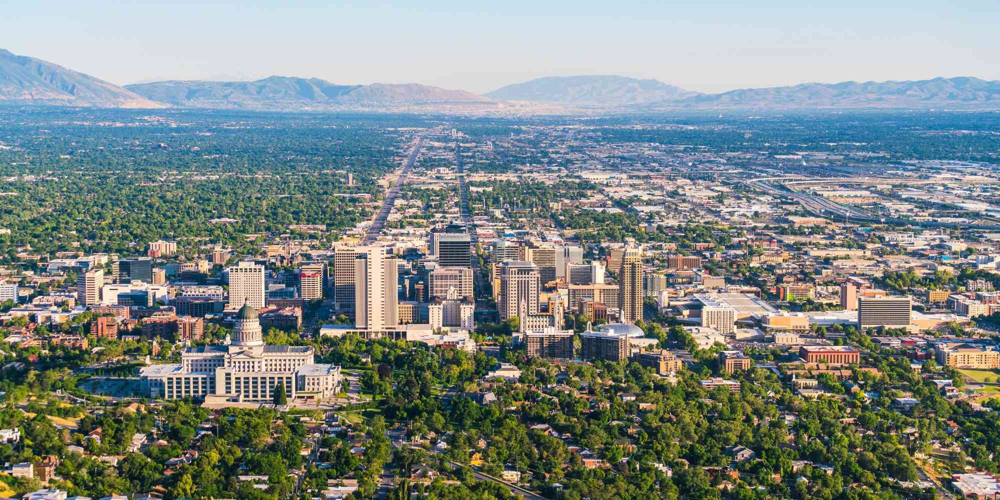 Stock image of Salt Lake City, Utah, showing buildings, streets, and mountains in the background