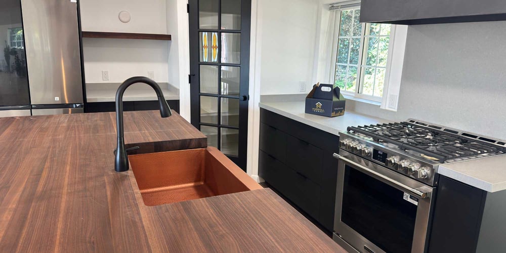 Remodeled kitchen with pantry, large island, and gas range by Marshall Homes in Salt Lake City