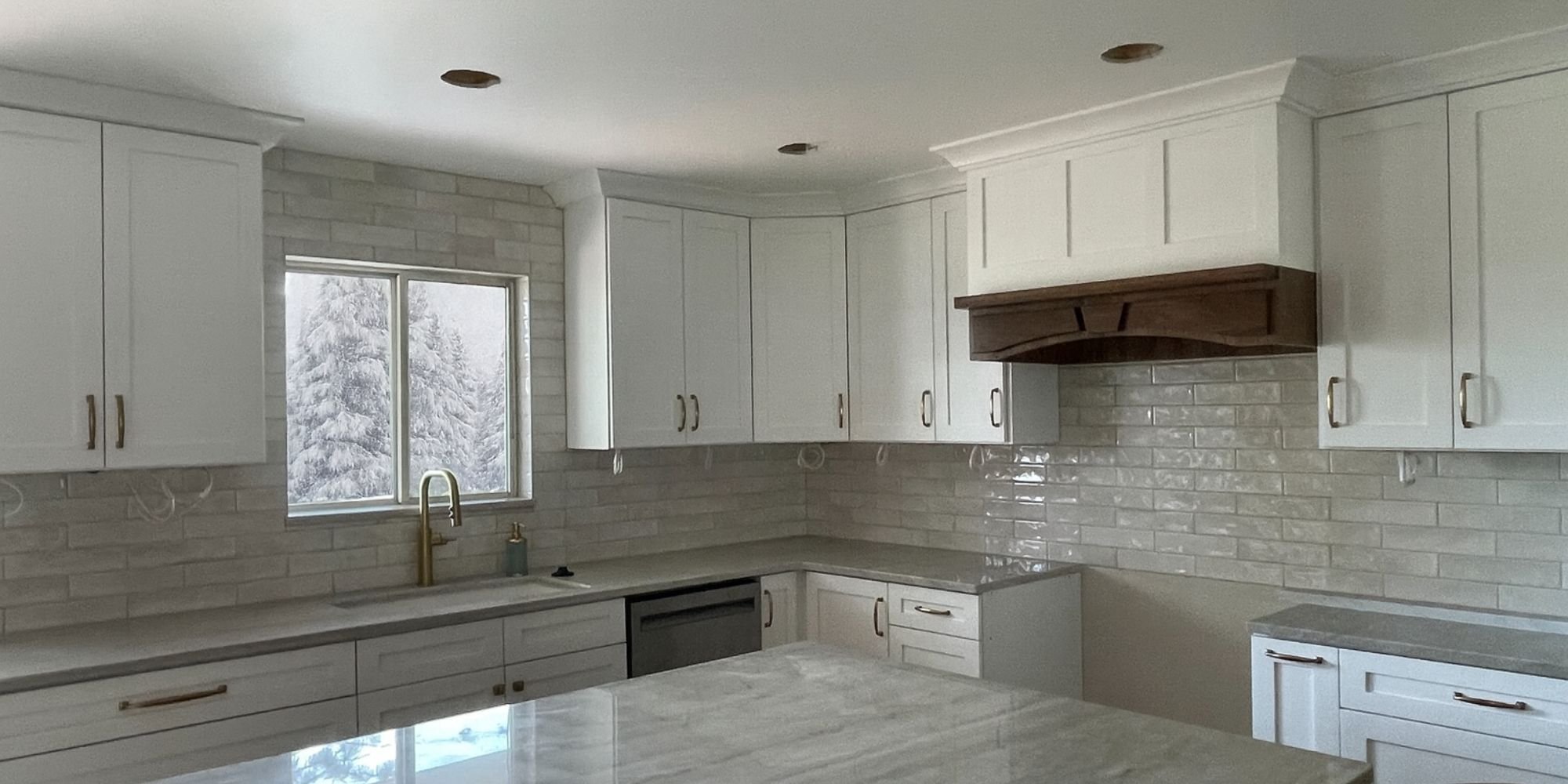 Salt Lake City kitchen remodel by Marshall Homes featuring modern backsplash and island