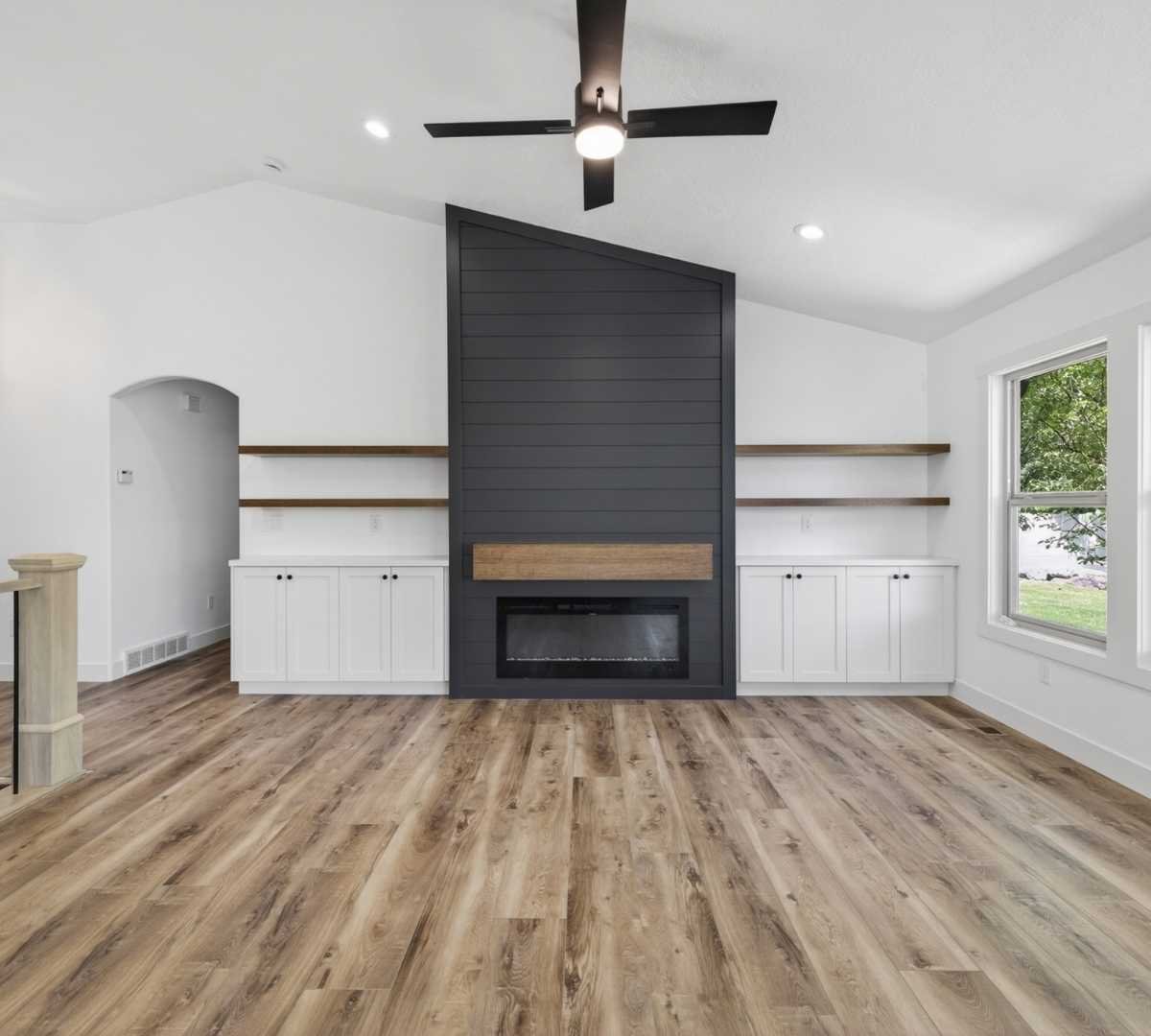 Image of living room remodel with custom fireplace wall and built-in storage by Marshall Homes in Herriman, UT