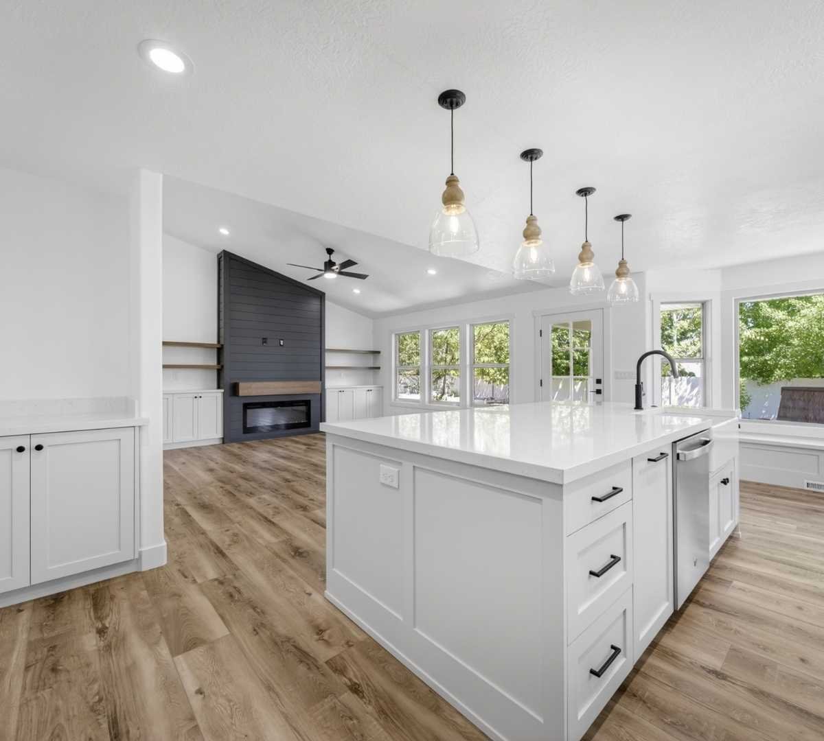 Photo of kitchen and living area remodel with large island and built-ins by Marshall Homes in Herriman, UT