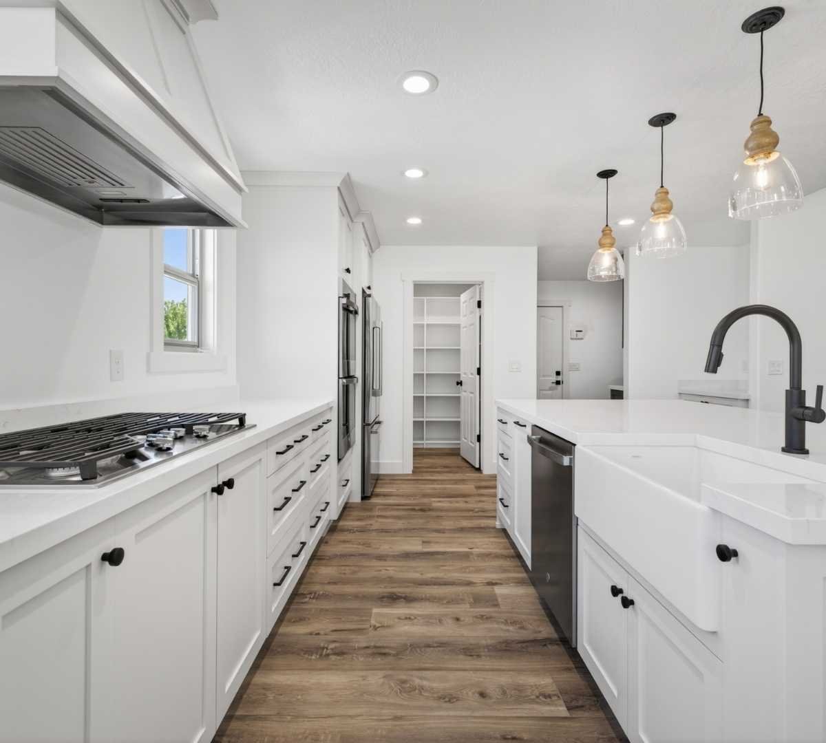 Photo of kitchen remodel with farmhouse sink and spacious pantry by Marshall Homes in Herriman, UT