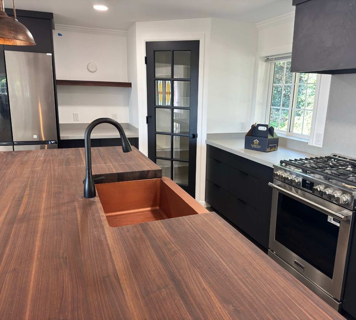 Modern kitchen remodel with wood-feature island by Marshall Homes Utah