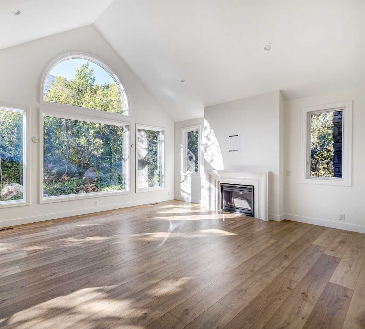 Image of an open living room with wood flooring by Marshall Homes Utah in Salt Lake City