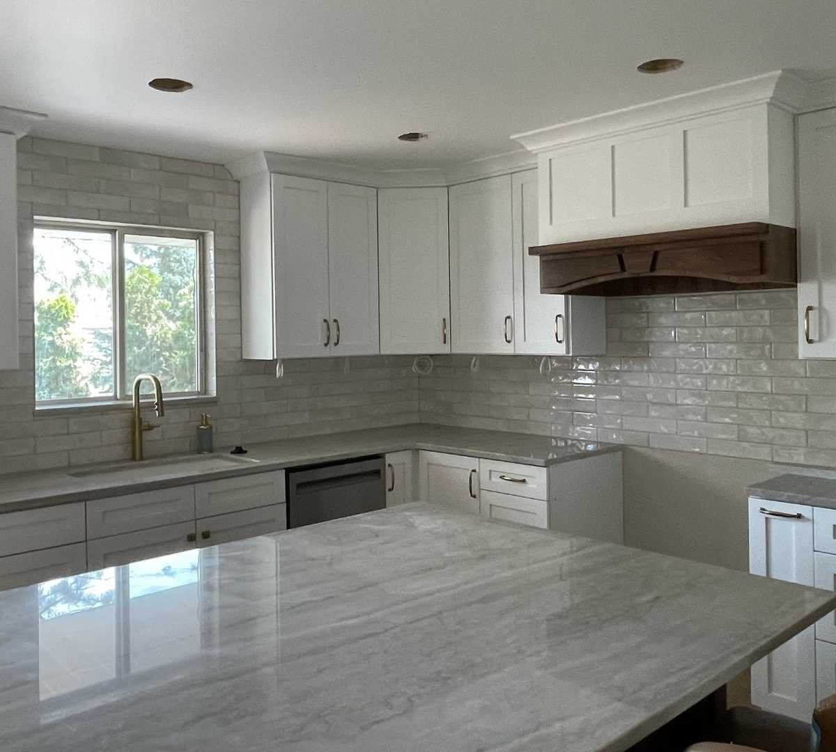 A bright kitchen remodel with white cabinets by Marshall Homes Utah in Salt Lake City