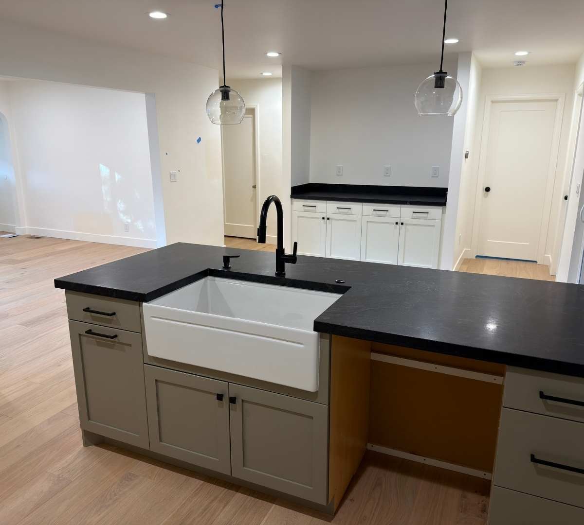 View from behind the kitchen island with a built-in sink in a home addition by Marshall Homes Utah