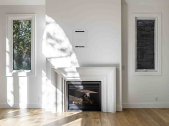 Image of great room remodel with modern fireplace, clean white walls, and sunlit windows in Olympus Cove, UT by Marshall Homes