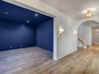 Image of home addition with new living space, blue accent room, and hardwood floors in Olympus Cove, UT by Marshall Homes