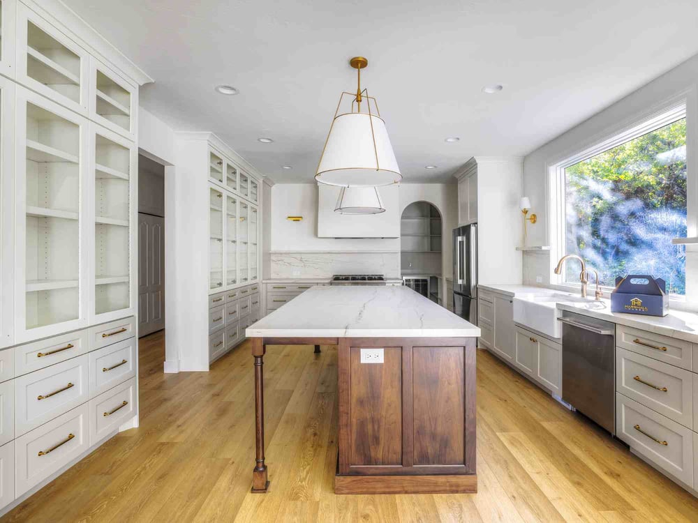 Image of kitchen remodel with large island, custom cabinetry, and marble countertops in Olympus Cove, UT by Marshall Homes