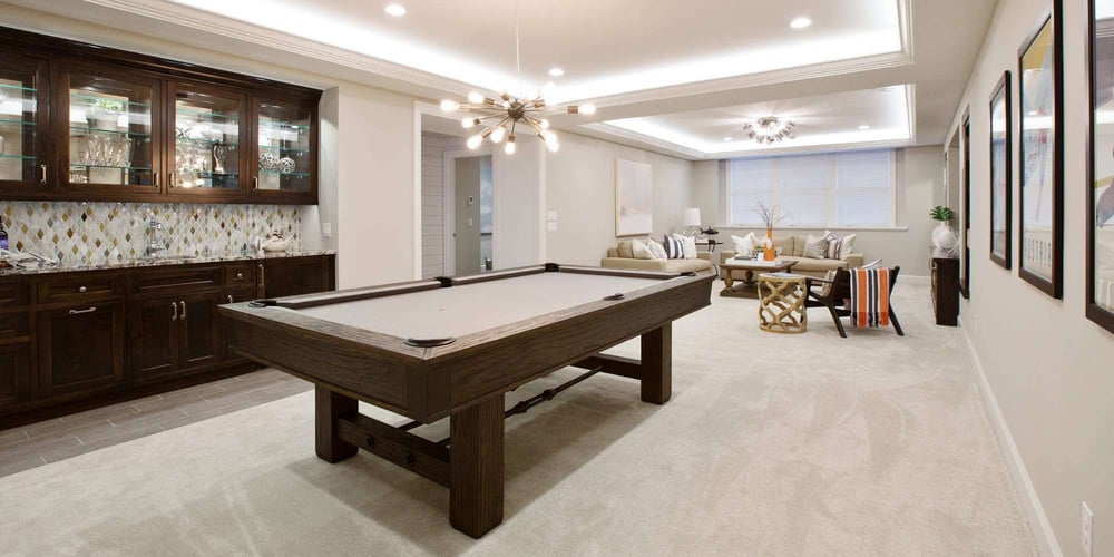 Recreation room with billiards table and seating area by Marshall Homes