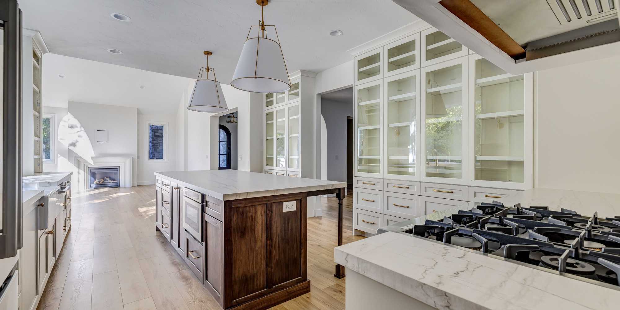 Image of kitchen remodel with custom cabinets, wood island, and open concept layout in Millcreek, UT by Marshall Homes