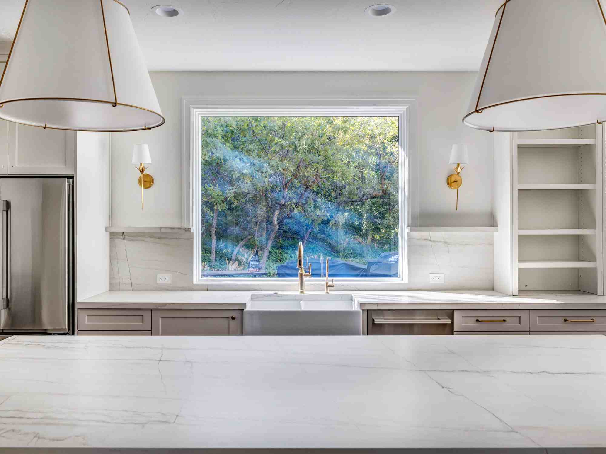 Bright kitchen remodel by Marshall Homes in Olympus Cove, Utah featuring large window, farmhouse sink, and clean design